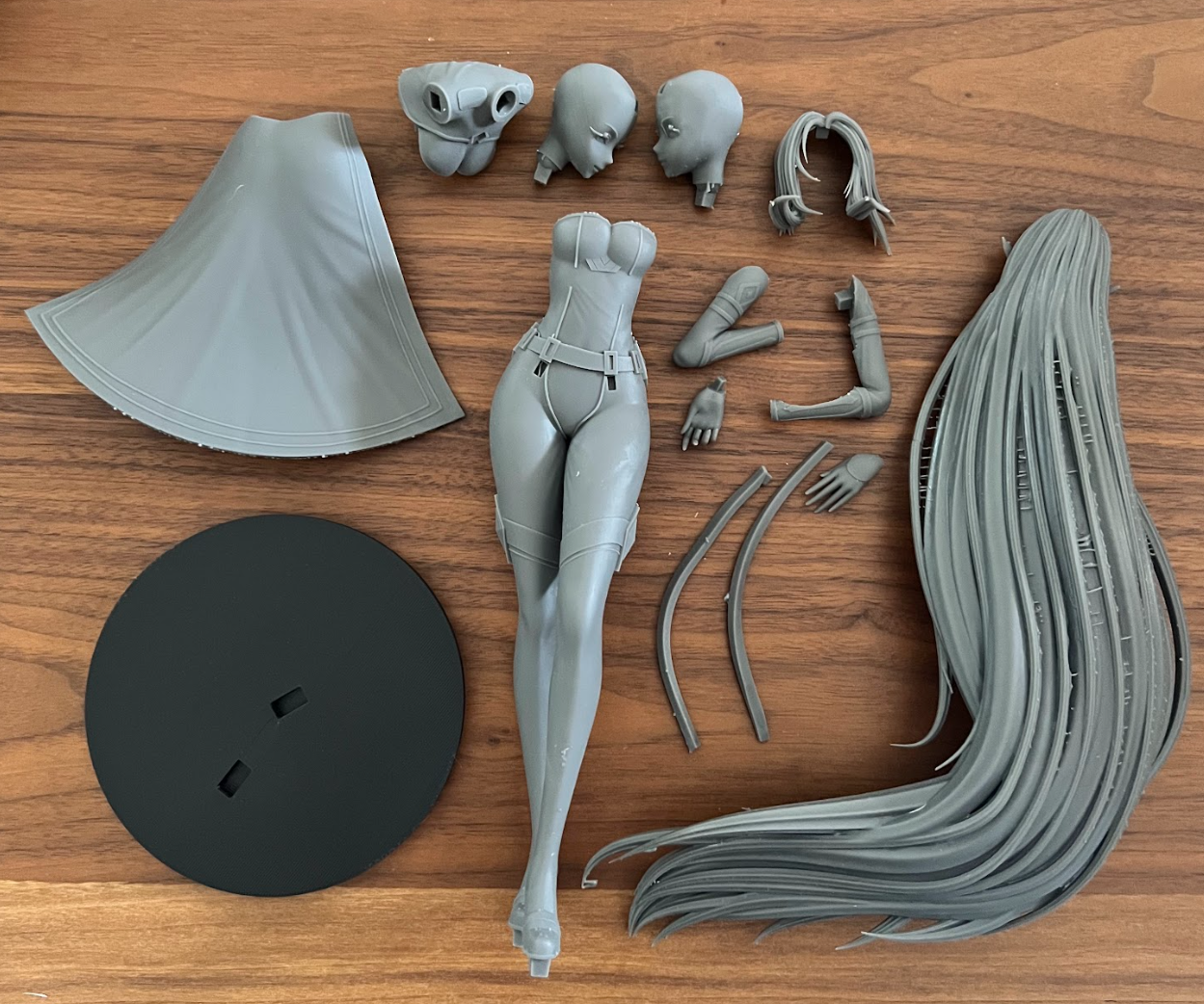 Separate resin figure parts and a base with visible keyed connection points.