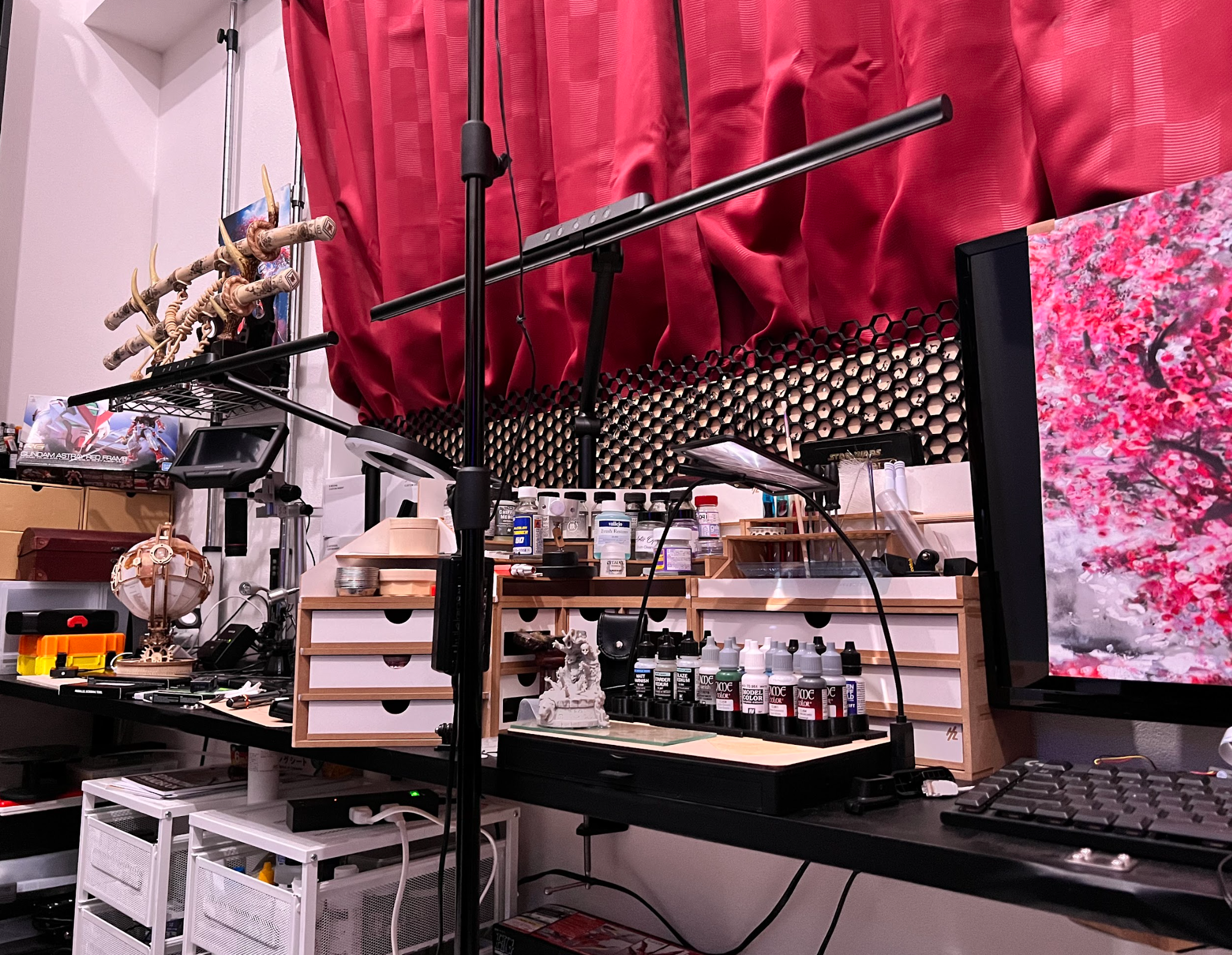 Dan’s model-making workbench with task lighting, paints, tools and projects.