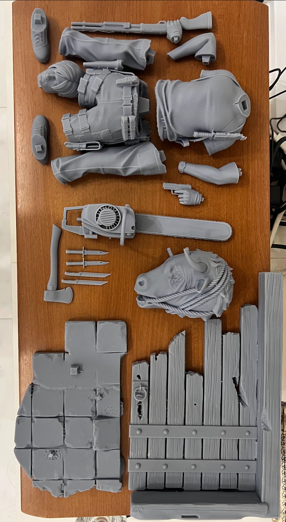 Figure, accessories and scenic base sections arranged before assembly.